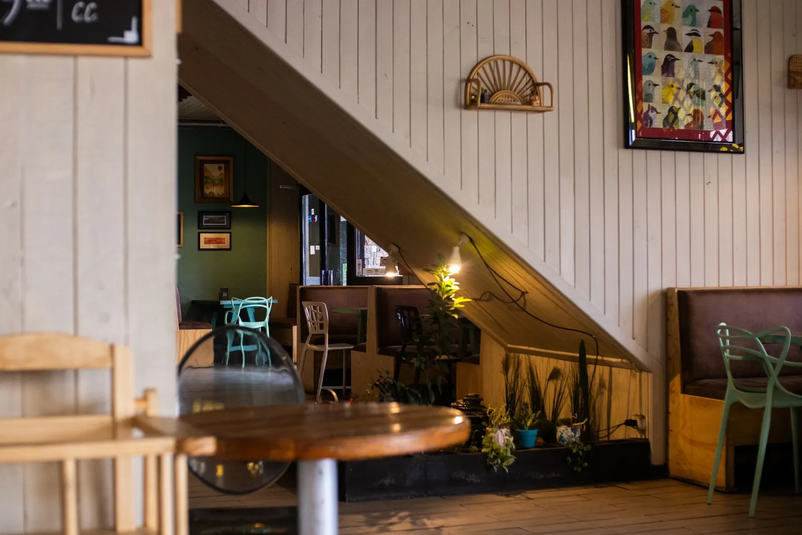 The dining room at dusk: warm wood, soft lamplight, and empty tables waiting for the evening